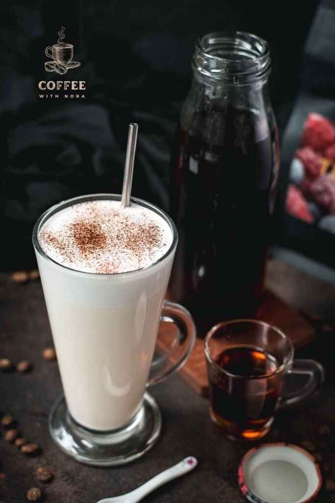 Beautiful glass filled with hot milk and homemade coffee syrup. Topped with frothed milk and dusted with cinnamon.