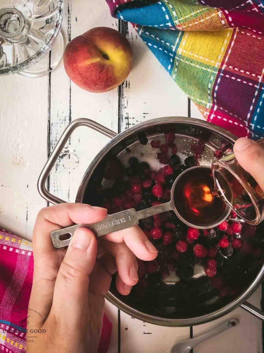 Add homemade chambord or raspberry liqueur to the saucepan.