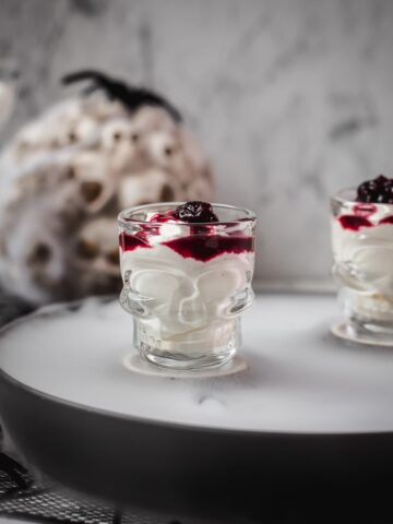 Spooky blood clot berry brains mousse, served in skull shaped shot glasses.