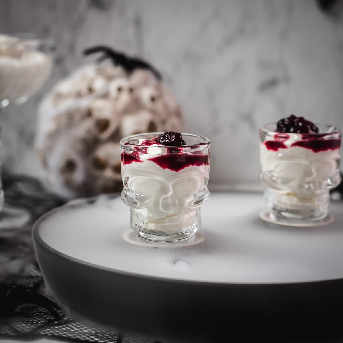 Spooky blood clot berry brains mousse, served in skull shaped shot glasses.