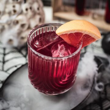 Spooky bloody sea breeze cocktail, served in a beautiful glass. Placed in a smoking black bowl.