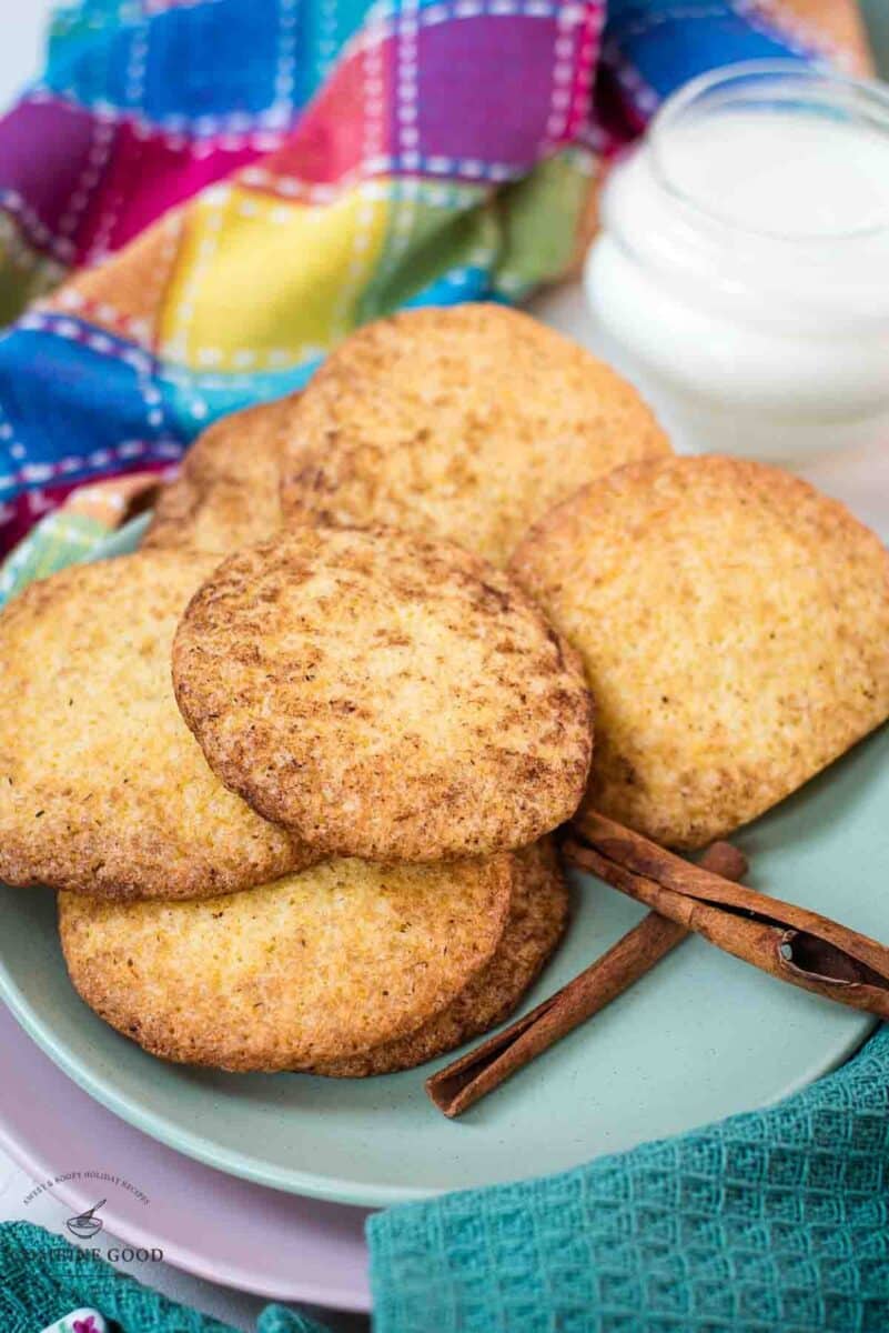 Fluffy snickerdoodle cookies placed on multicolored plates.