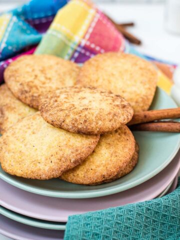 Fluffy snickerdoodle cookies placed on multicolored plates.