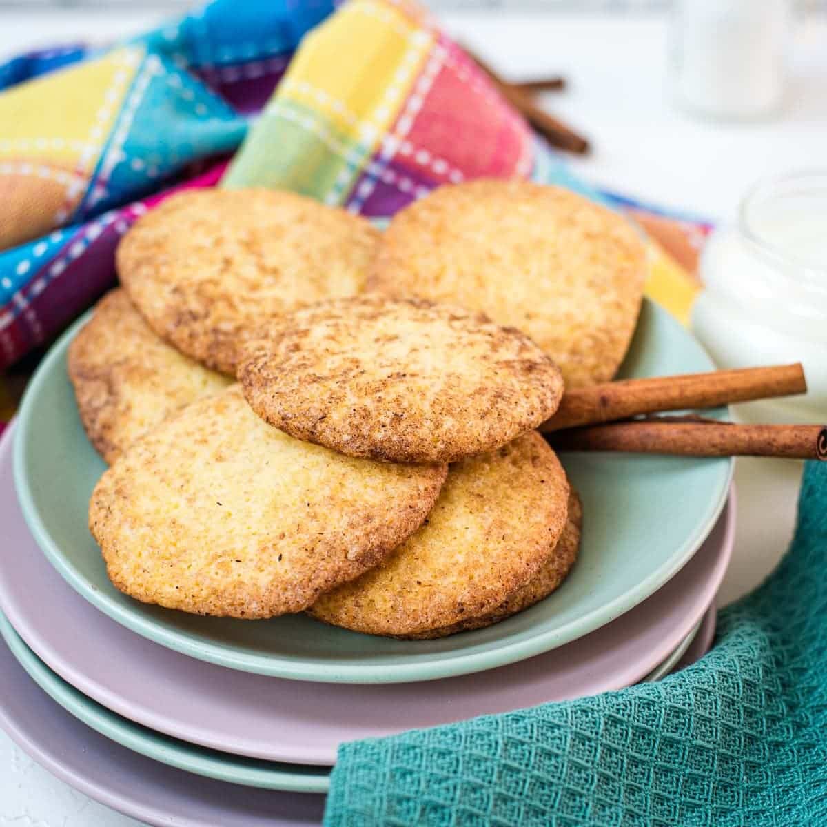 Fluffy snickerdoodle cookies placed on multicolored plates.