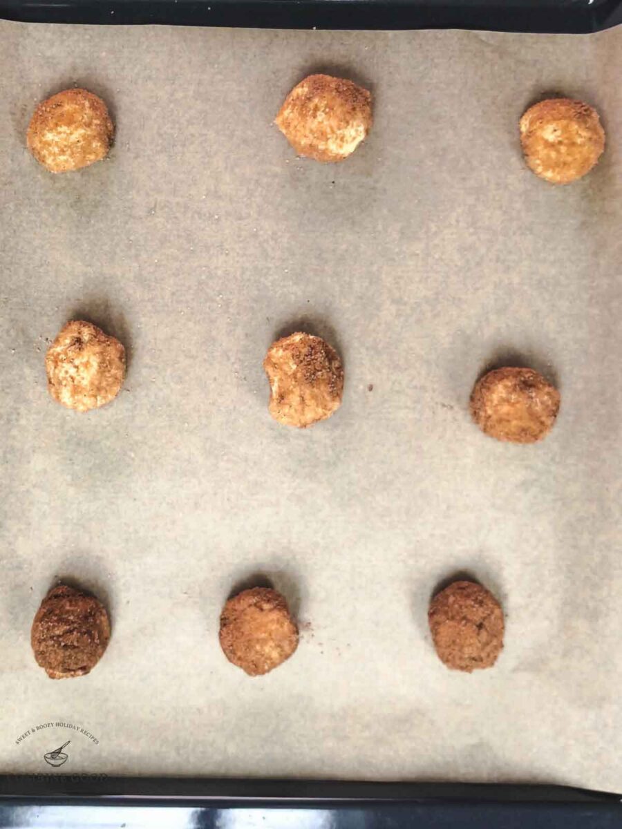 Place the coated cookie dough balls on a baking sheet lined with parchment paper.