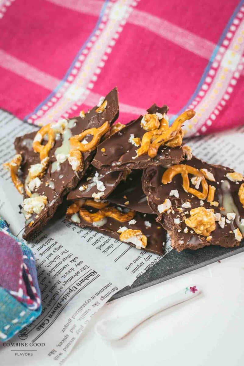 Delicious salted caramel popcorn bark placed on black slate.