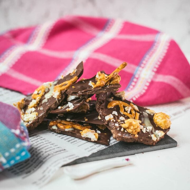 Delicious salted caramel popcorn bark placed on black slate.