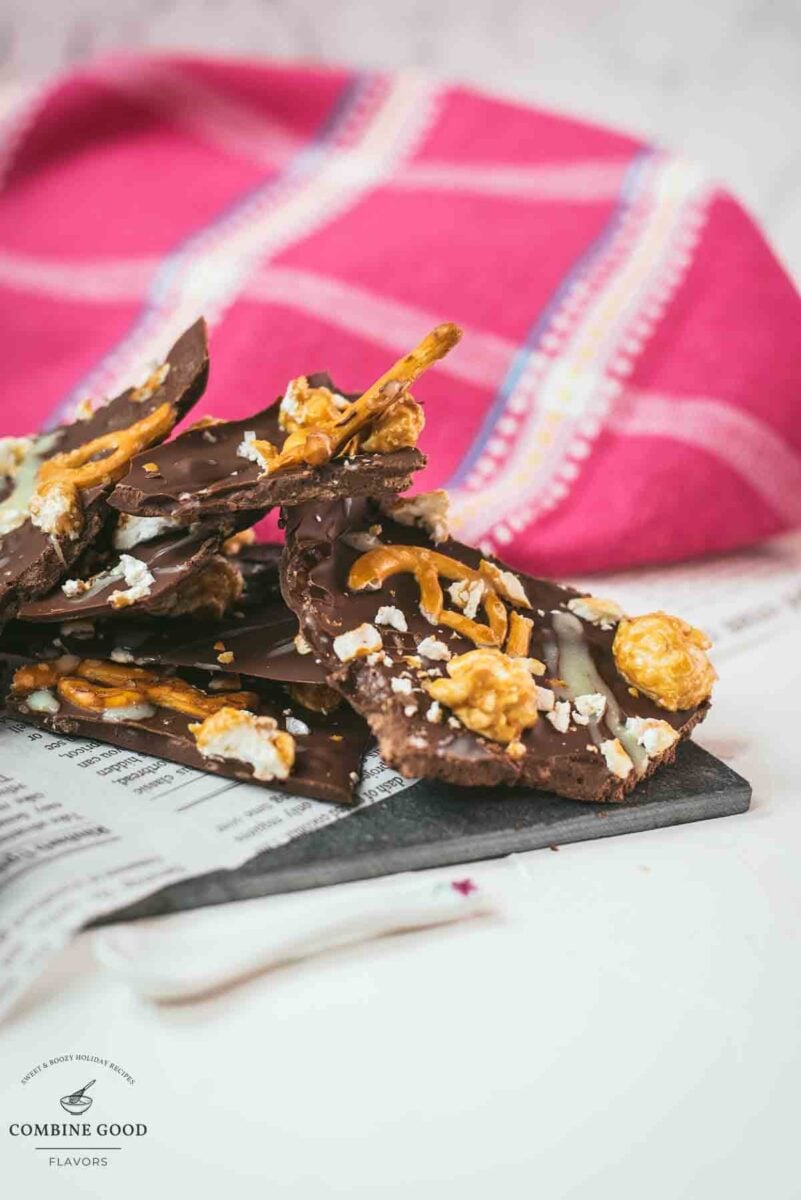 Delicious salted caramel popcorn bark placed on black slate.