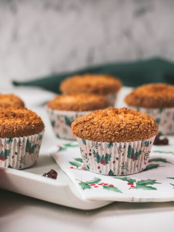 Cute egg yolk cranberry coconut muffins in Christmas styled muffin liners.