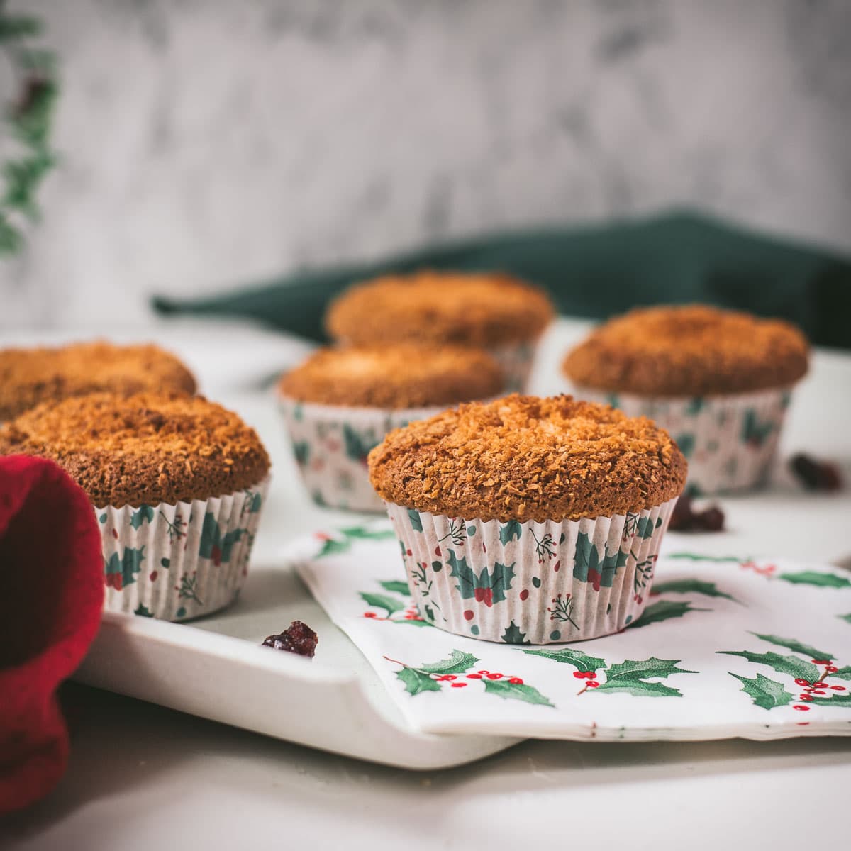 Cute egg yolk cranberry coconut muffins in Christmas styled muffin liners.