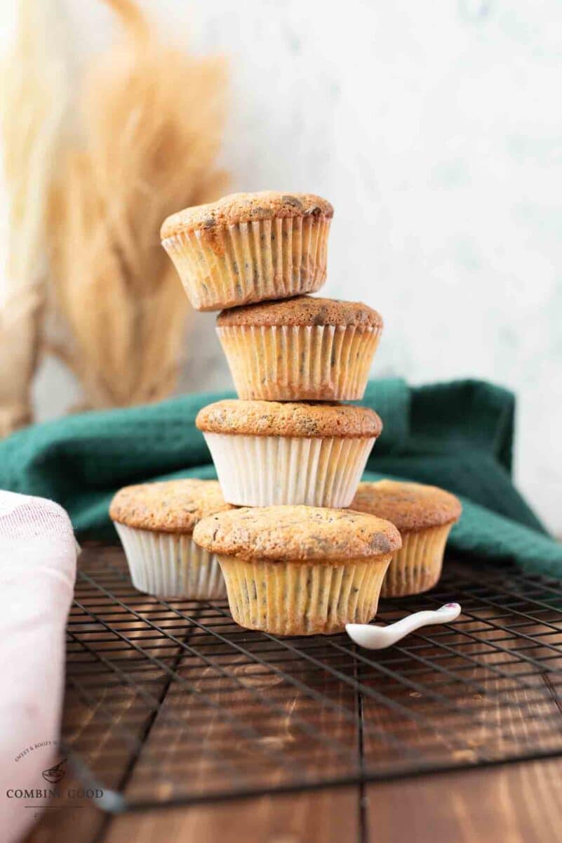 Delicious 4 egg yolk chocolate chip muffins stacked on cooling rack.