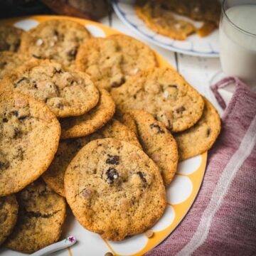 Divine salted caramel chocolate chip cookies, served on colorful platter.
