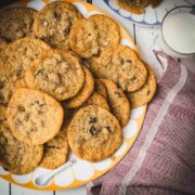 Divine salted caramel chocolate chip cookies, served on colorful platter.