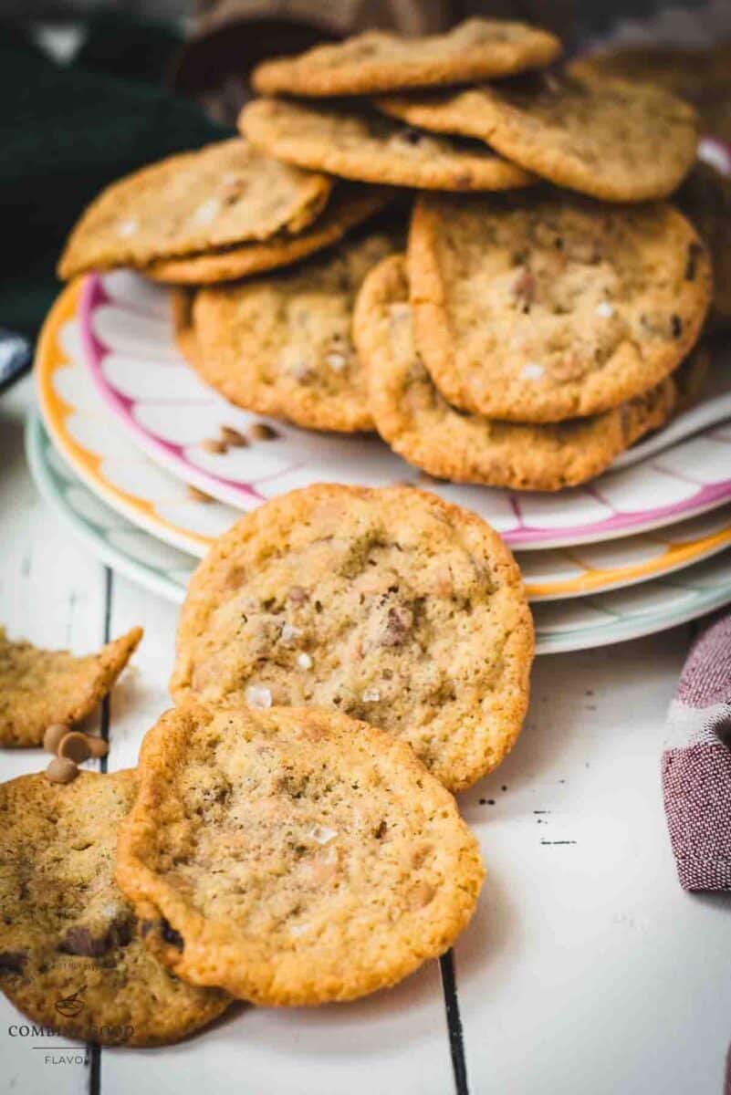 Divine salted caramel chocolate chip cookies, served on colorful platter.