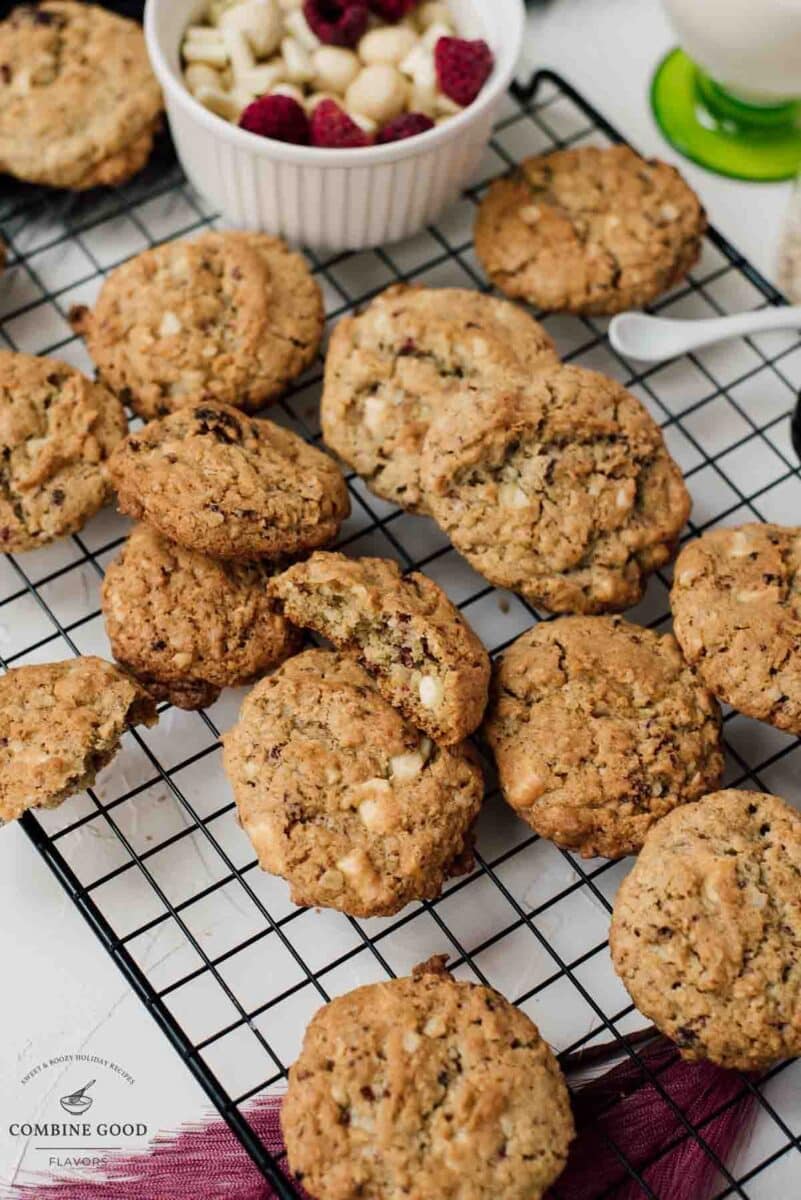 Raspberry macadamia oatmeal white chocolate chip cookies placed on white plate.