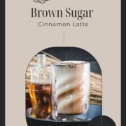 Curved glass filled with delicious brown sugar cinnamon latte, placed in a cast iron pan on a green felt base.