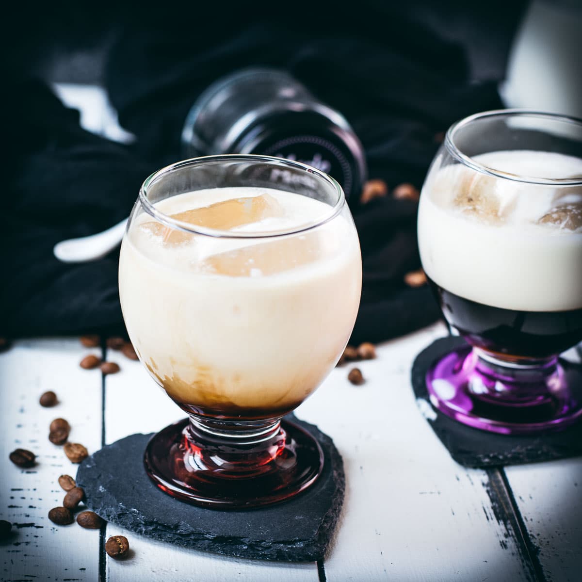 Dairy free cold brew brown sugar white Russian, served in gorgeous glasses with purple and red bottom.