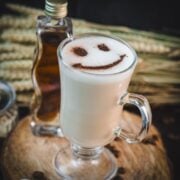 Cute brown sugar oat milk coffee, with a smiley face dusted on top of it.
