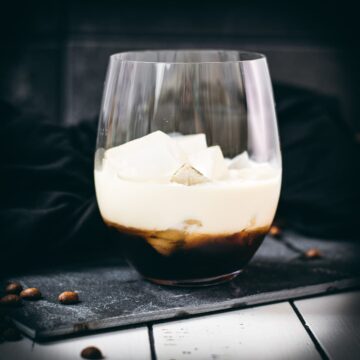Simple GT glass, filled with delicious brown sugar white Russian. Placed on a black slate plate.