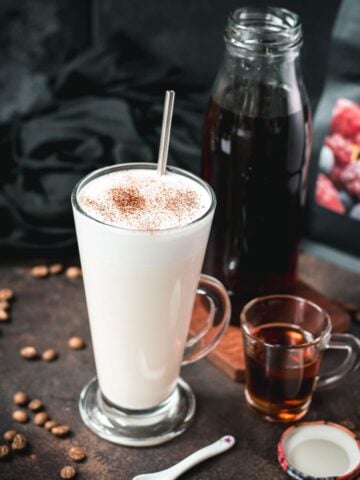 Beautiful glass filled with hot milk and homemade coffee syrup. Topped with frothed milk and dusted with cinnamon.