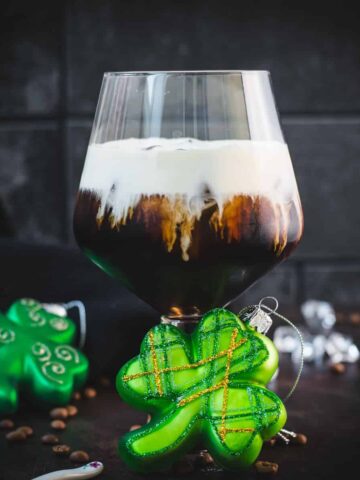 Gorgeous serving glass, filled with delicious iced irish coffee (made with homemade cold brew). Floating on top, a decadent slightly whipped cream.
