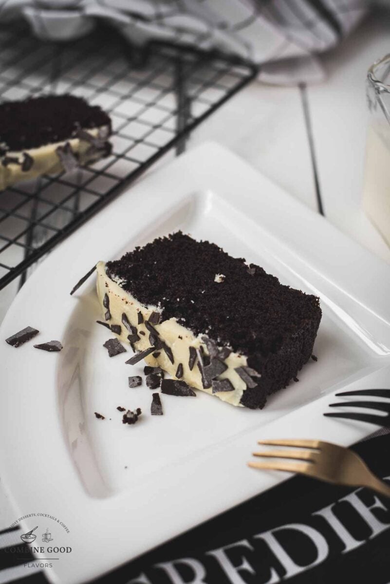 Divine chocolate buttermilk loaf cake with white chocolate frosting, sprinkled with chocolate shavings.