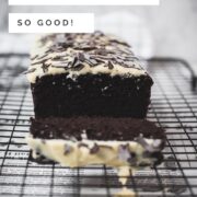 Divine chocolate buttermilk loaf cake with white chocolate frosting, sprinkled with chocolate shavings.