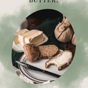 Buttered bread with a bite taken out of it, placed on a white plate with a brown rim.