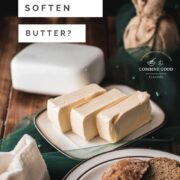 Butter, sliced on white plate with brown colored rim, next to a plate with sliced bread.