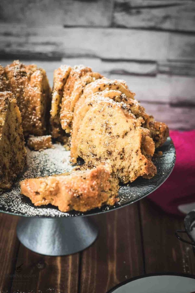 Delicious vanilla bundt cake with chocolate sprinkles, served on light blue cake stand.