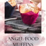 Cute angel food muffins, dusted with powdered sugar, placed on marbled plate and served with a delicious cafe latte.