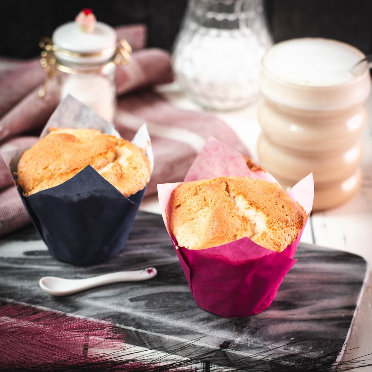 Cute angel food muffins, placed on marbled plate and served with a delicious cafe latte.