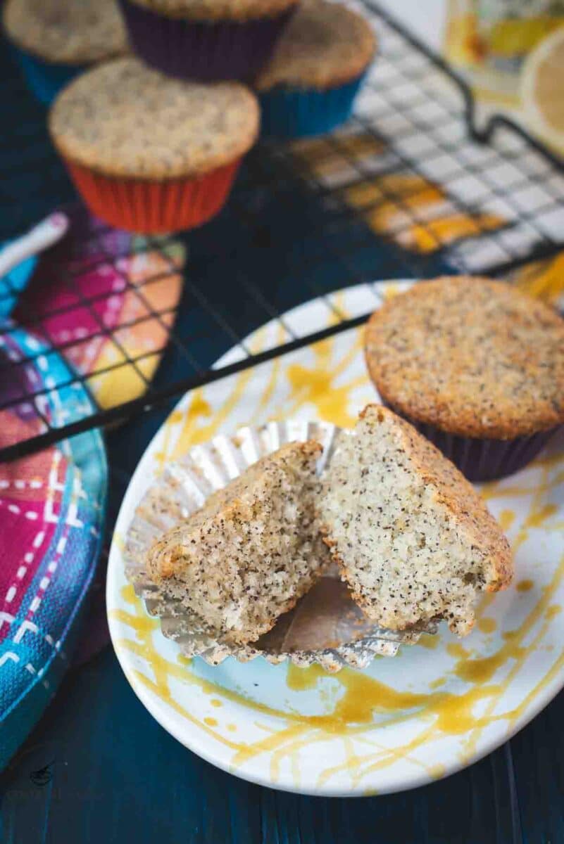 Sliced lemon poppy seed muffin, placed on gorgeous yellow white plate.