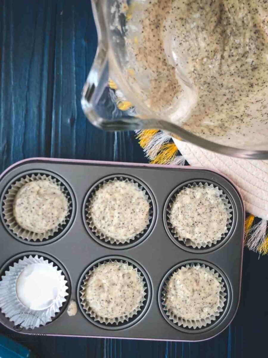 Baking tray, filled with lemon poppy seed muffin batter prior baking.