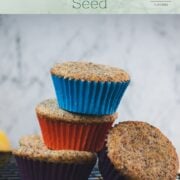 A cute little tower of lemon poppy seed muffins, arranged on a cooling rack.