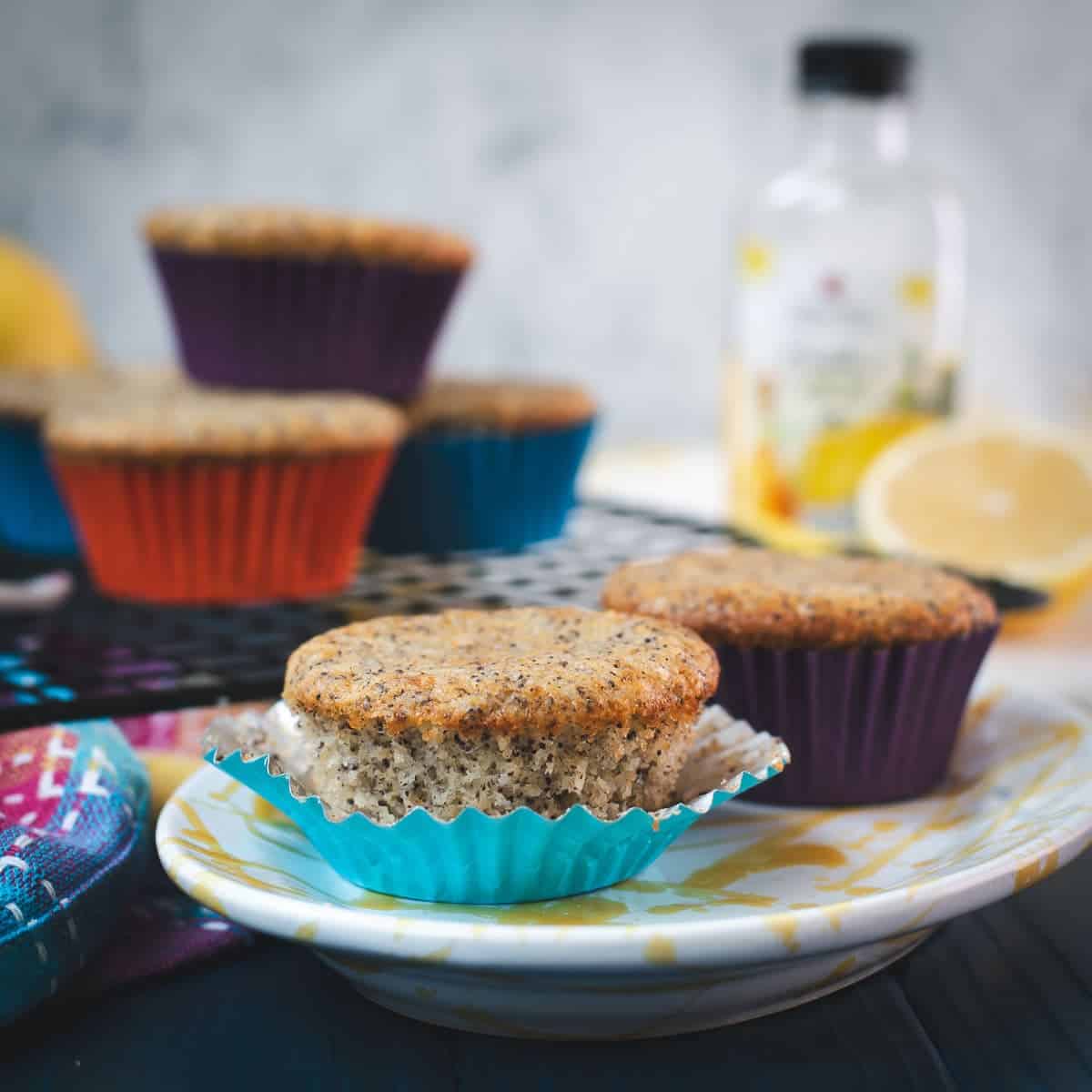 Lemon poppy seed muffins, placed on gorgeous yellow white plate.