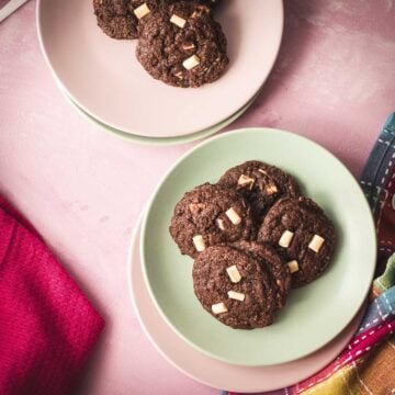 Divine white chocolate chip cookies with an incredible dark chocolate dough. Placed on pink-green plates.