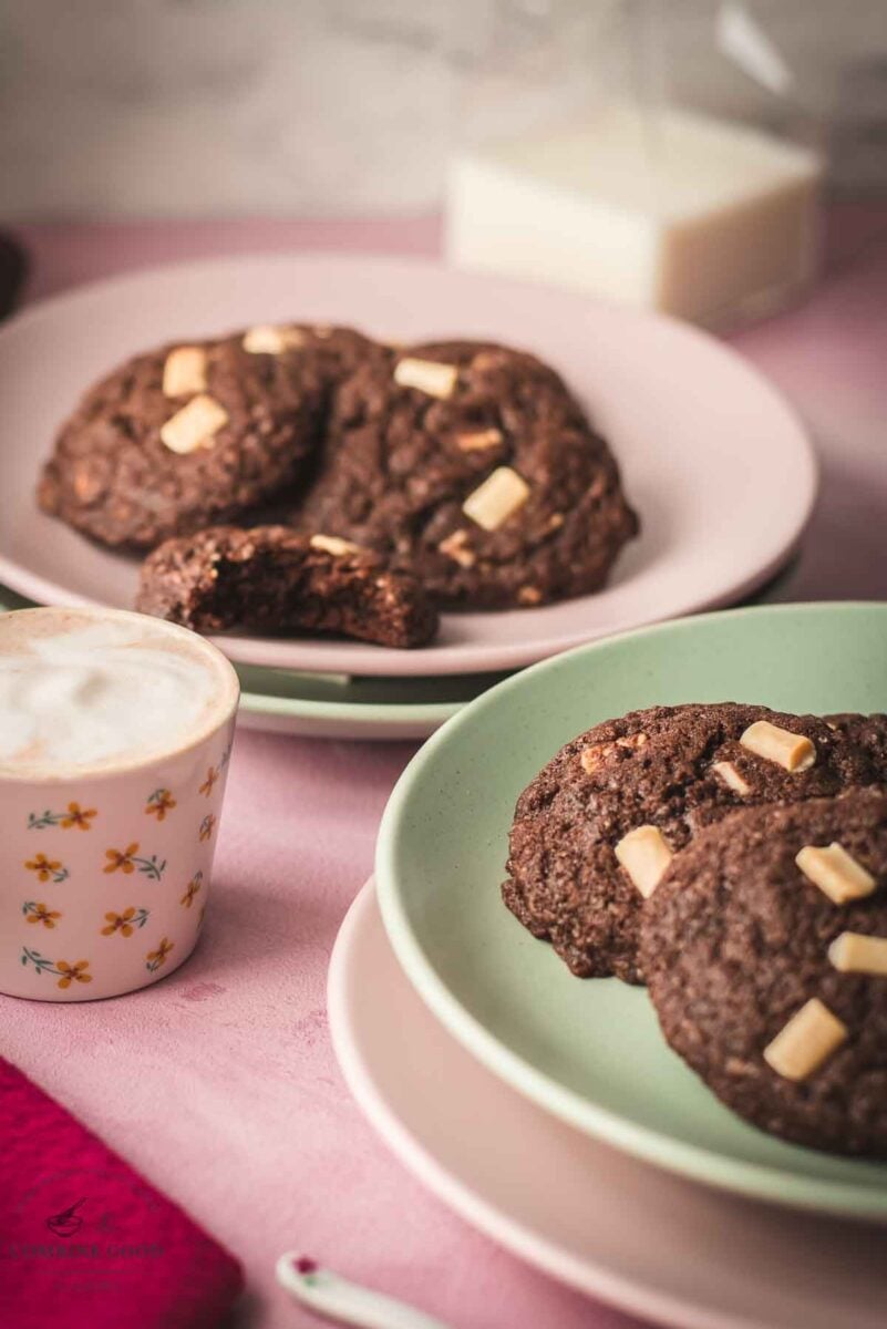 Divine white chocolate chip cookies with an incredible dark chocolate dough. Placed on pink-green plates.