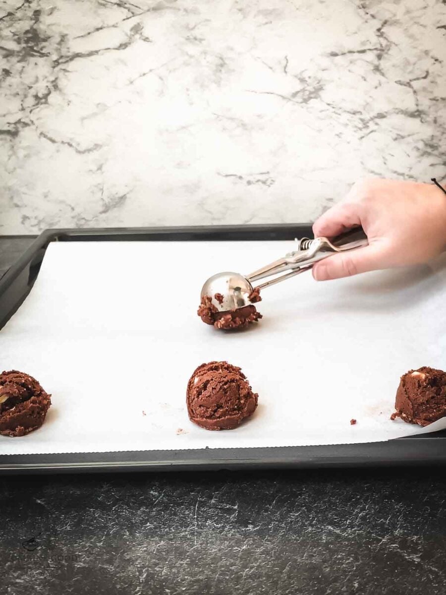 Scoop the cookie dough balls on a baking try lined with parchment paper.