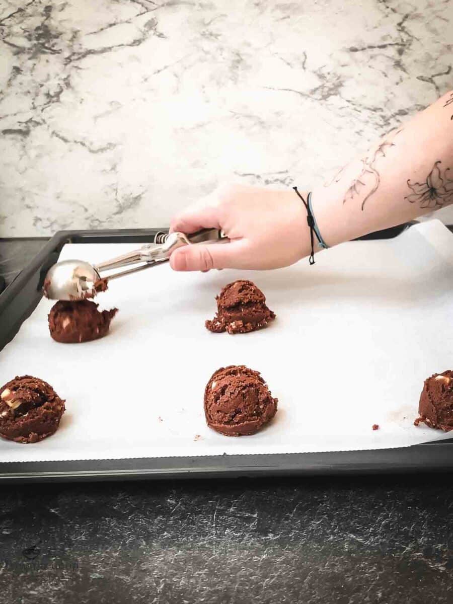 Scoop the cookie dough balls on a baking try lined with parchment paper.