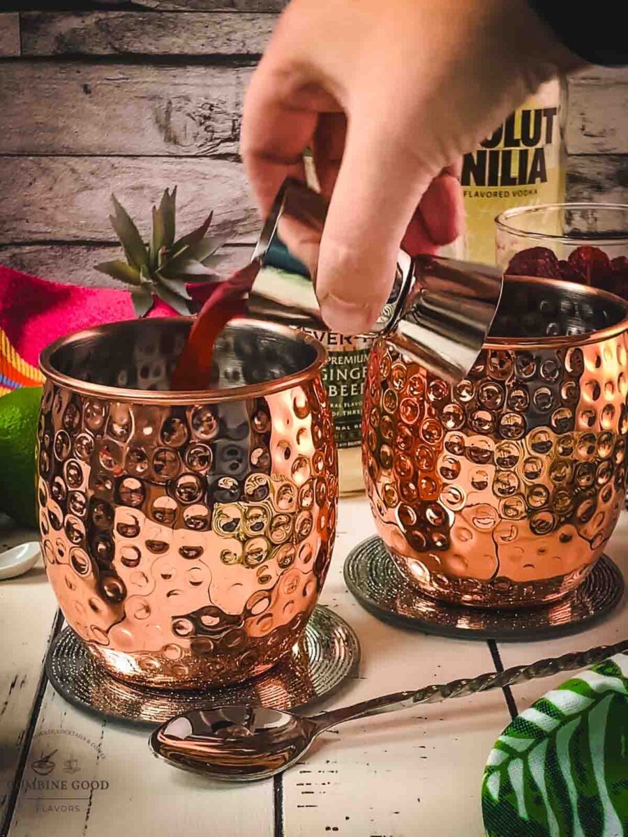Add raspberry syrup to the copper mug.