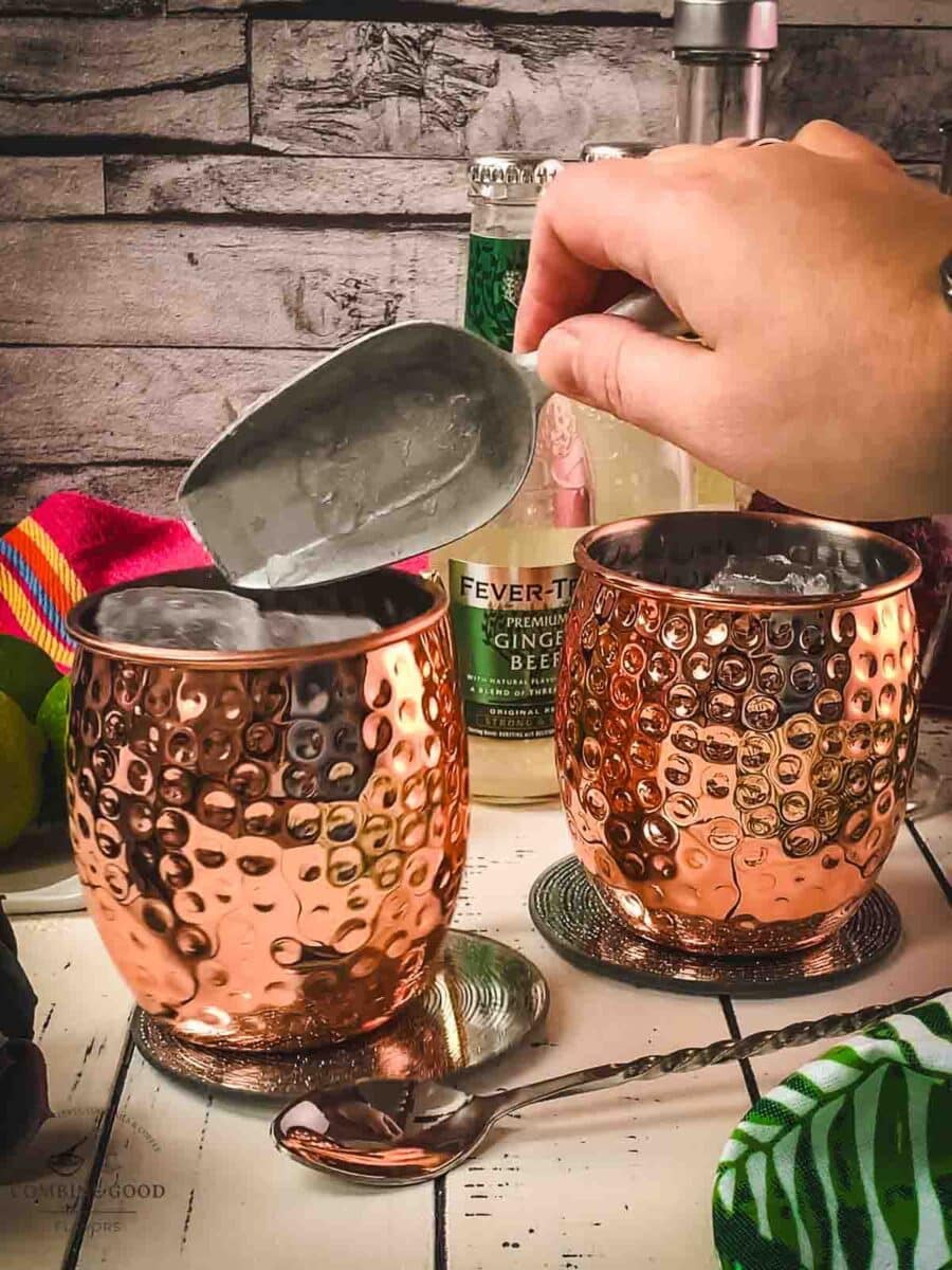 Add cubed ice to the copper mug.