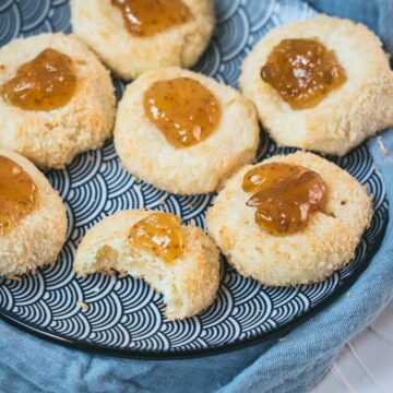 Delicious fig jam cookies, placed on a blue white plate, on cookie is already missing a bite.