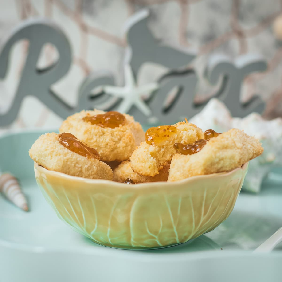 Delicious fig jam cookies, placed in a yellow bowl, on cookie is already missing a bite.