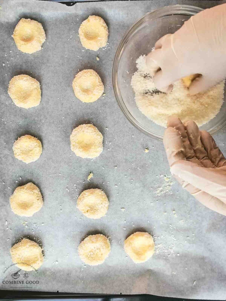 Roll the fig jam cookie dough balls in shredded coconut before placing it on the baking sheet.