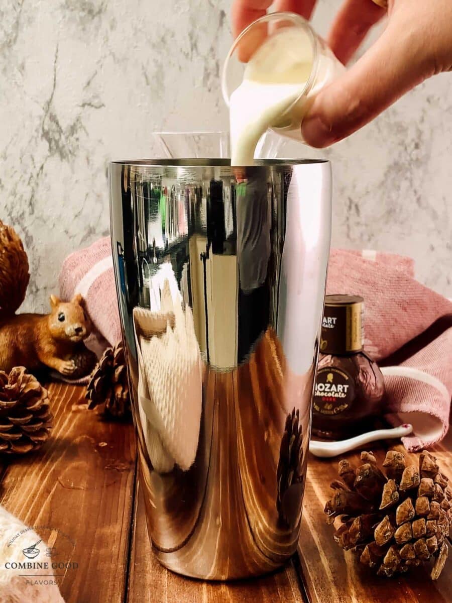 Pouring fresh cream into the Brandy Alexander mixture