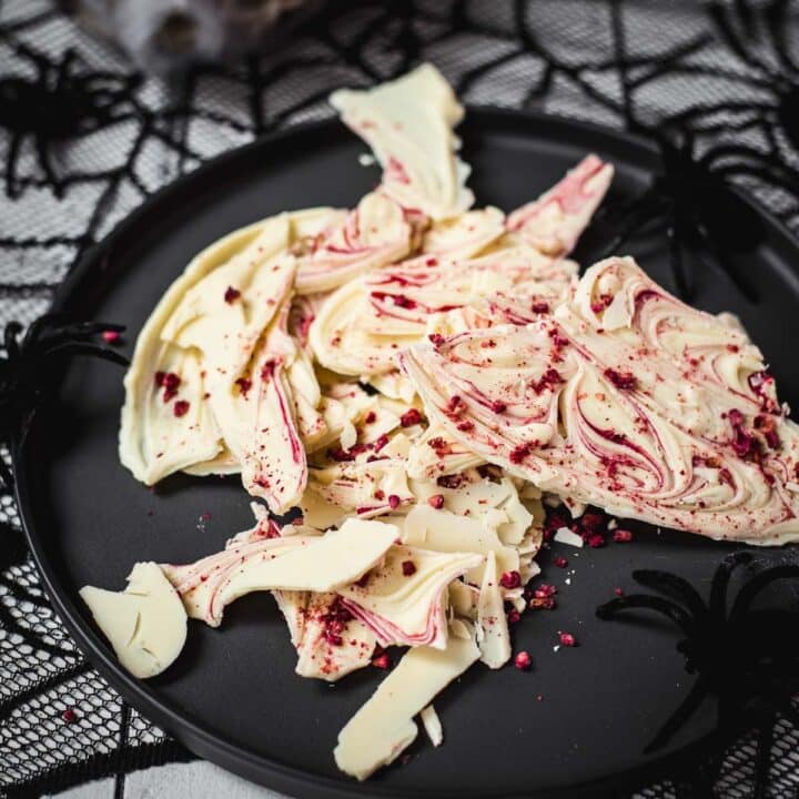 Stunning and elegant - this Halloween bark, made with crushed raspberries, white chocolate, and berry blood syrup is to die for!
