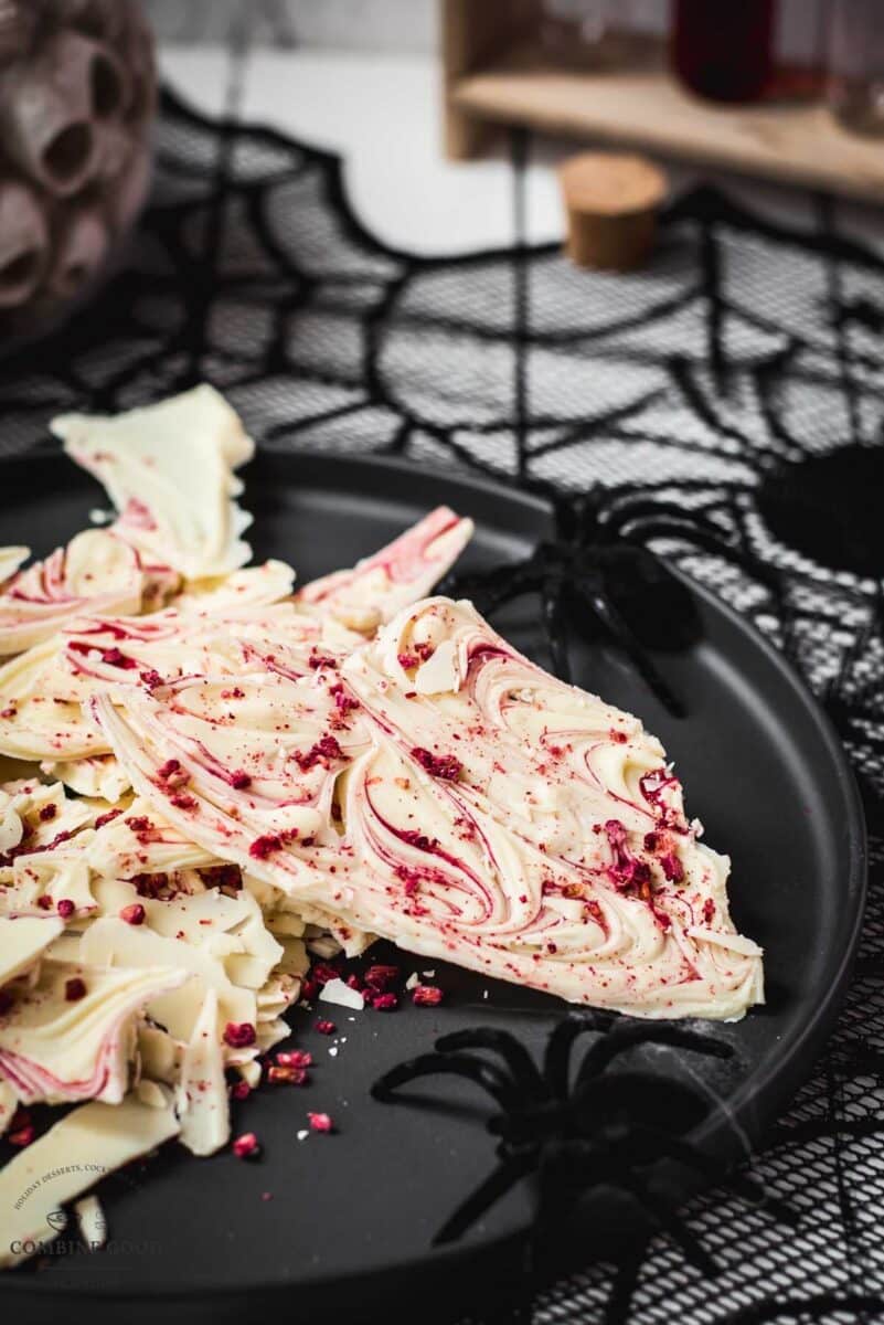 Stunning and elegant - this Halloween bark, made with crushed raspberries, white chocolate, and berry blood syrup is to die for!