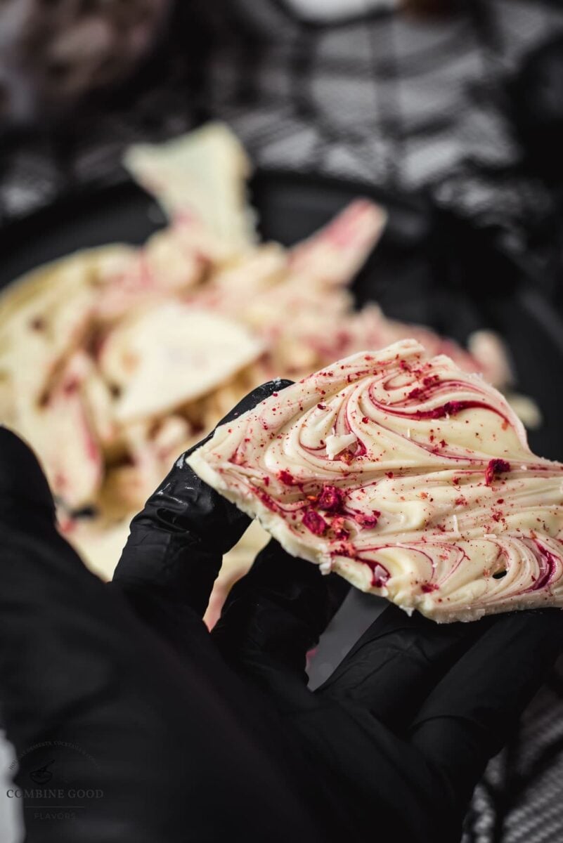 Stunning Halloween bark, held in black gloved hand.