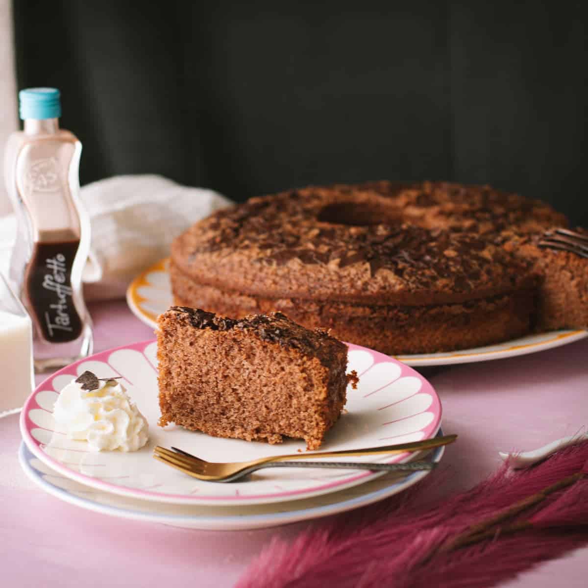 Fluffy chocolate cum cake with potato starch and chocolate rum liqueur. A slice placed on a beautiful, colorful plate.